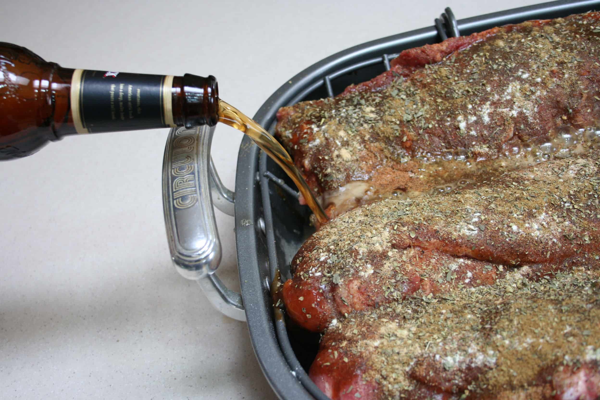 Pouring beer under bbq ribs