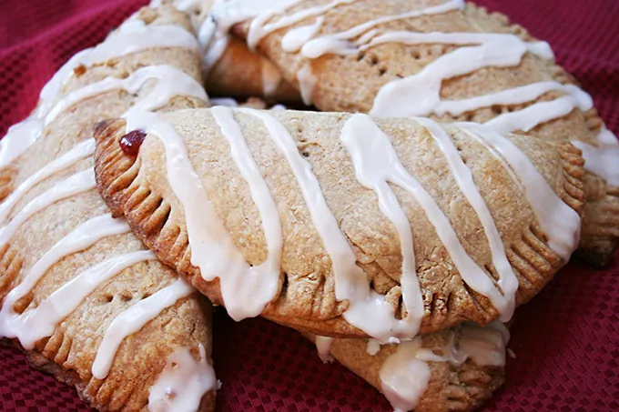 Cherry turnovers in a pile on a red napkin.