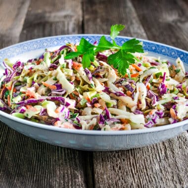 Coleslaw in a bowl on a wood table