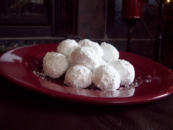 Russian tea cakes on a red plate