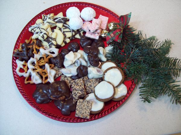 Russian tea cakes and candies on a red tray for Christmas