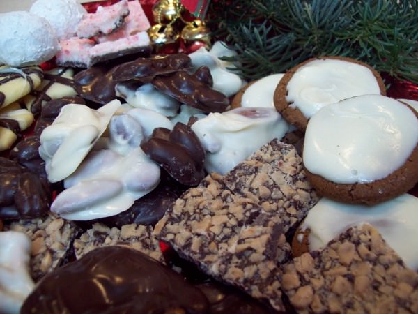 toffee, molasses cookies and chocolate covered almonds on a tray