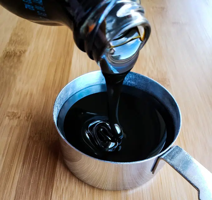molasses poured into a measuring cup