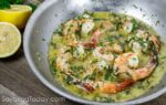 Shrimp cooked in scampi sauce in the pan.