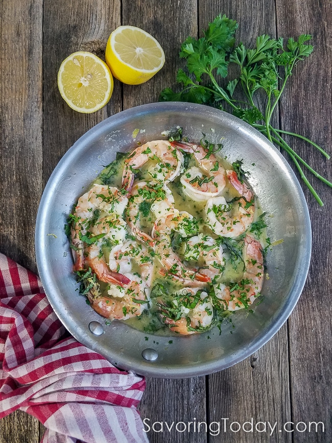 Shrimp Scampi in a skillet with lemon and parsley to show the recipe ingredients.