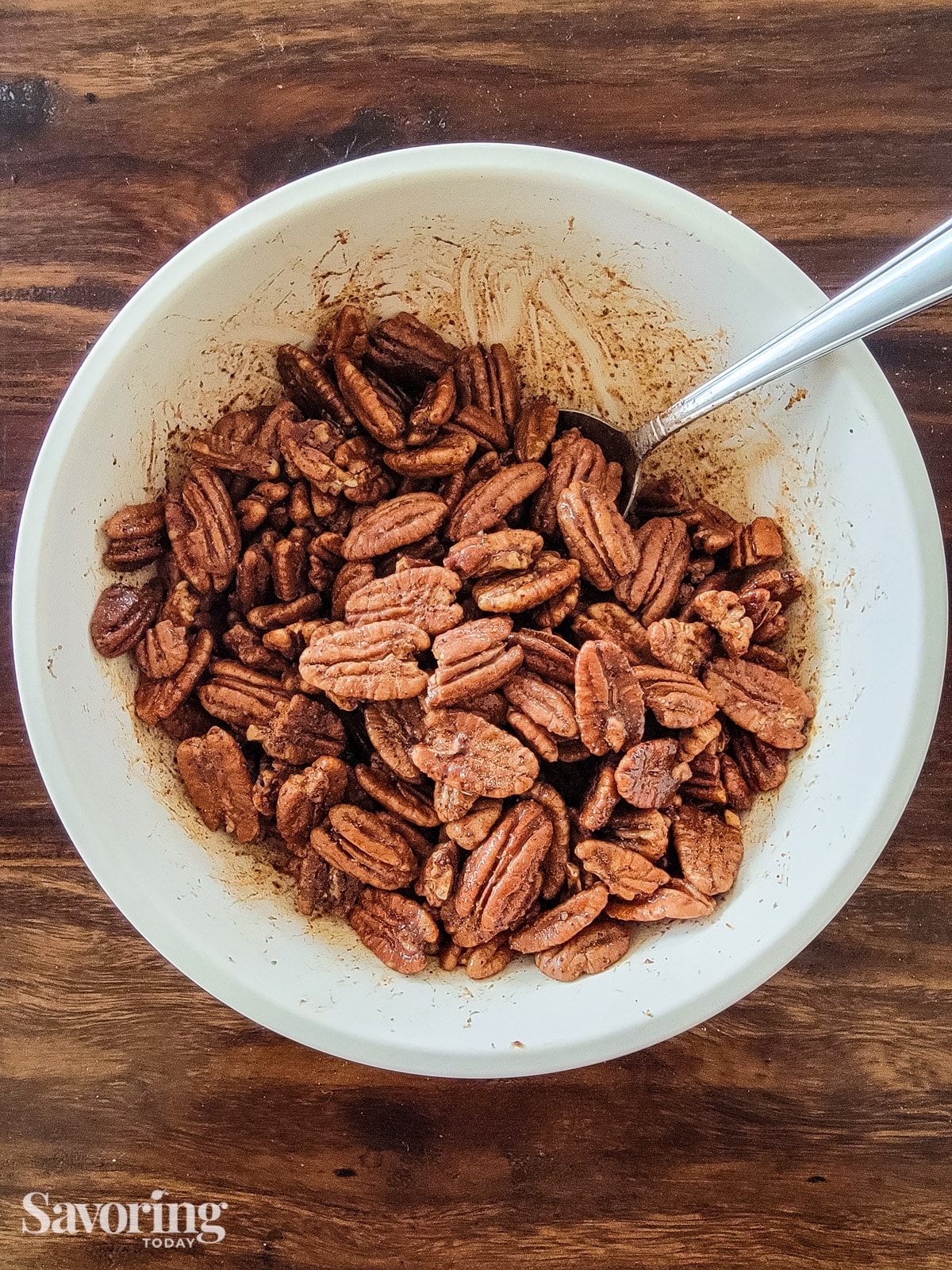 Mixing pecans with cinnamon, sugar, and chipotle