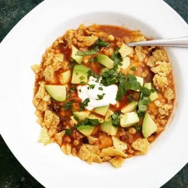 Chicken tortilla soup made with homemade broth and topped with fresh avocado and cilantro.