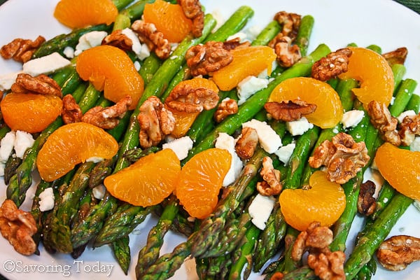 Roasted Asparagus with oranges, feta and walnuts on a white platter