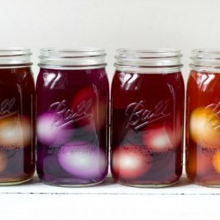 Eggs in mason jars colored in natural food dye.