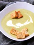 asparagus soup with croutons in a white bowl