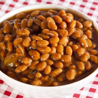 Fresh Homemade BBQ Baked Beans on a checked tablecloth