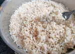 cooked brown rice in a pan fluffed with a fork