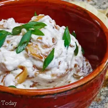 caramelized onion dip in a red bowl