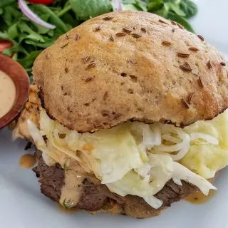 Classic Reuben sandwich made with uncured corn beef, Swiss cheese, sourkraut, and topped with Russian dressing. Served on homemade sprouted rye buns with a salad on the side.