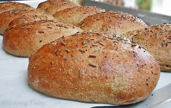 Burger buns fresh from the oven on a baking tray.