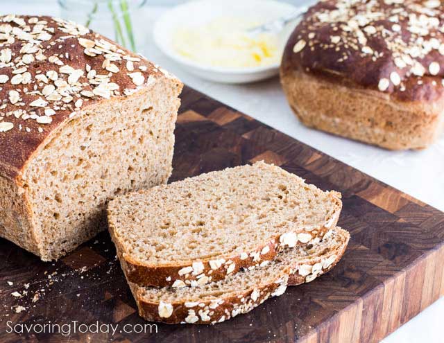 Sprouted Whole Wheat Sandwich Bread sliced on a cutting board with butter.