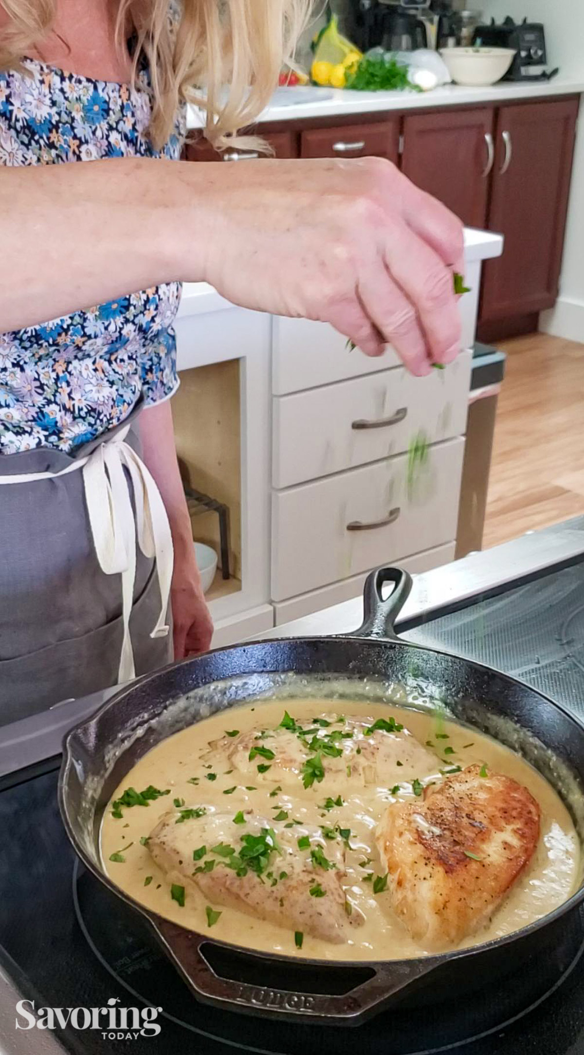 sprinkling parsley over the chicken and sauce in skillet to serve