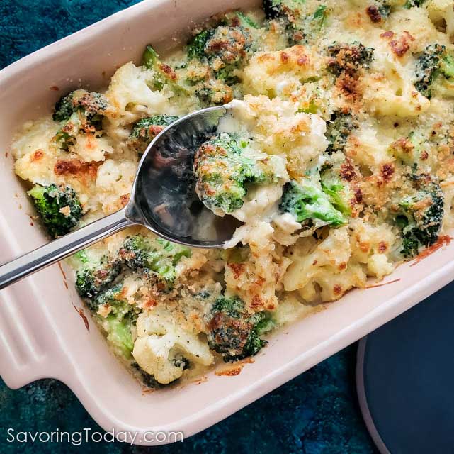 Broccoli and cauliflower baked in a cheese sauce scooped with a spoon.