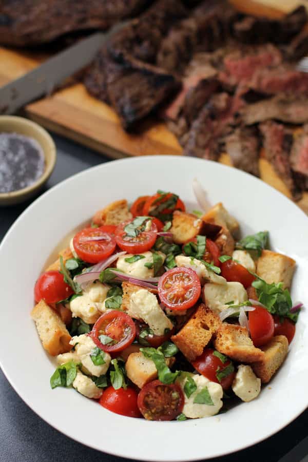 caprese-panzanella salad in a white bowl