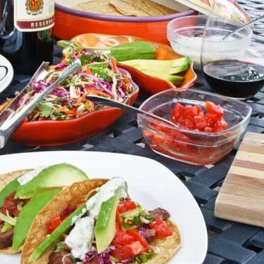 Skirt Steak Tacos served with pico and rainbow slaw.