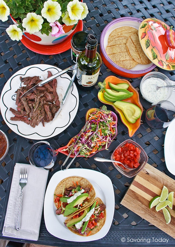 Steak tacos served with fresh avocados, rainbow slaw and tomatoes.