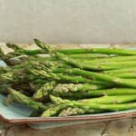 Raw asparagus ready to be roasted for a Steak and Scallop dinner side dish.