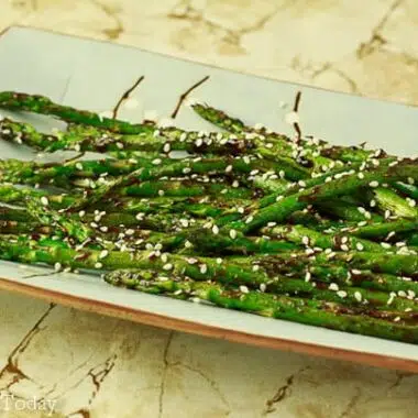 Grilled asparagus with hoisin-sesame sauce makes an easy grilled side dish.