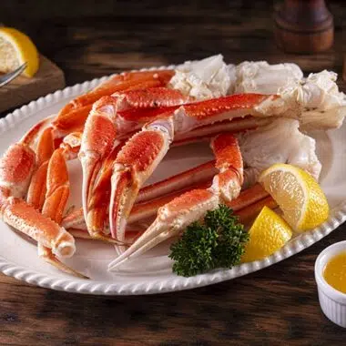 crab legs on a white platter with drawn butter