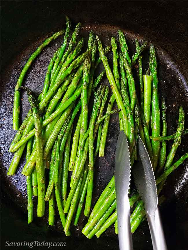 Roasted asparagus in a cast iron pan.