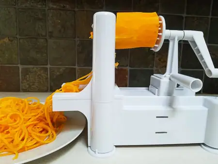 Spiral slicing butternut squash into noodles.