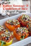 Stuffed peppers with caramelized onions and pistachios in a white ceramic baking dish.