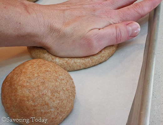 flattening dough for buns with the palm of the hand