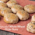 Sprouted wheat slider buns on a place mat.