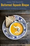 butternut squash soup in a bowl set in a blue and white plate with sliced bread