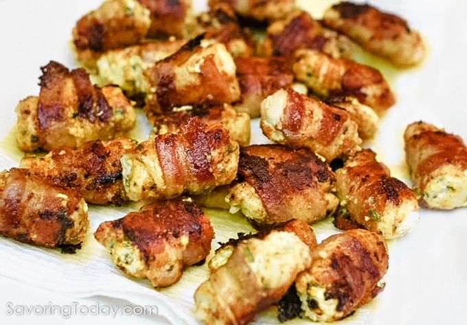 Bacon wrapped around chicken stuffed with cream cheese and jalapenos.