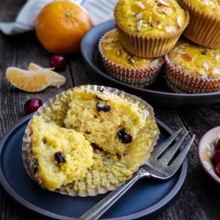 Cranberry Orange Muffin on a dark blue plate with a fork