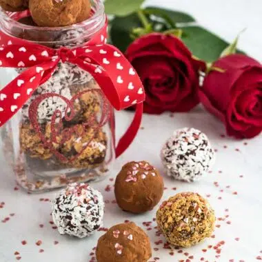 Homemade chocolate truffles prepared as a gift in a jar with roses.