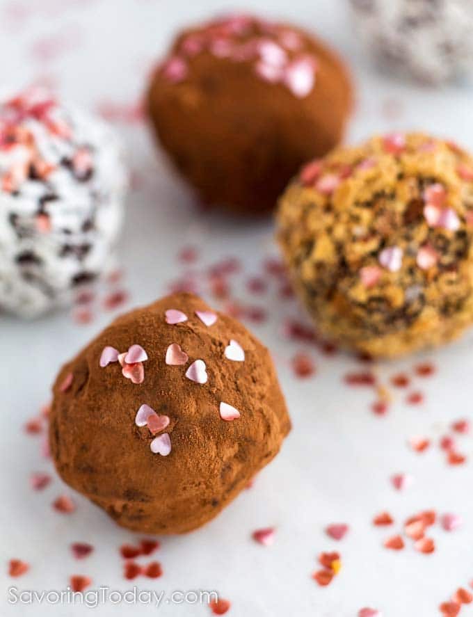 Close up of pink hearts sprinkled on chocolate truffles for Valentine's Day