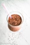 Salted mocha almond breakfast smoothie with a pink striped straw.