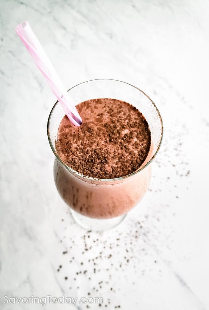 Salted mocha almond breakfast smoothie with a pink striped straw.