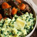 Sweet Potato mashed with kale beside beef stew.