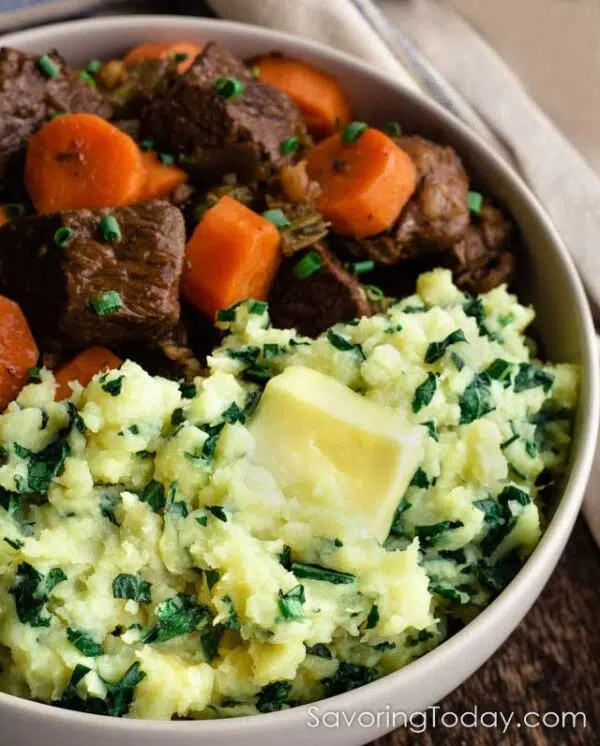 Sweet Potato mashed with kale beside beef stew.