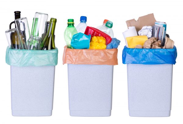 Recycling bins divided by plastic, glass, and paper.