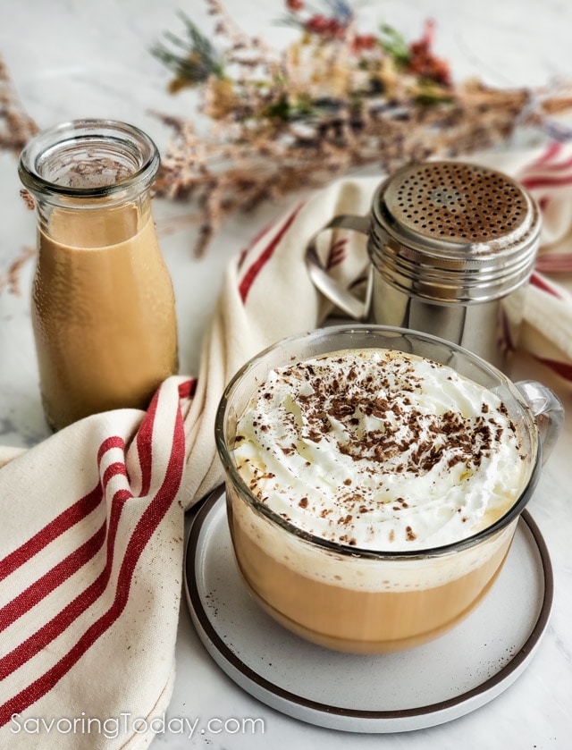 Irish Coffee Creamer topped with whipped cream and cocoa sprinkles.