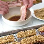 dipping bacon in maple syrup for candied bacon