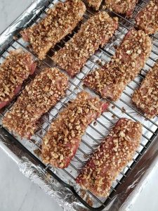 Pecan maple candied bacon on a rack ready for the oven.