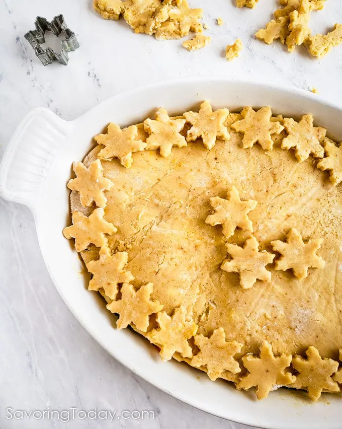 Pastry crust decorated with small star cutouts.