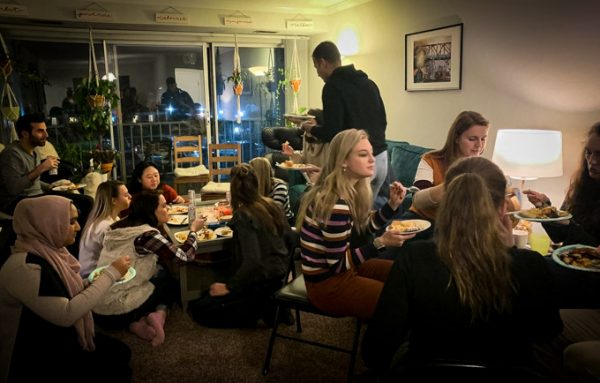Friends gathering in a living room for a Friendsgiving party