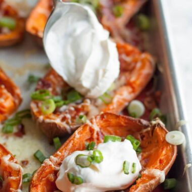Sweet potato skins on a pan with sour cream