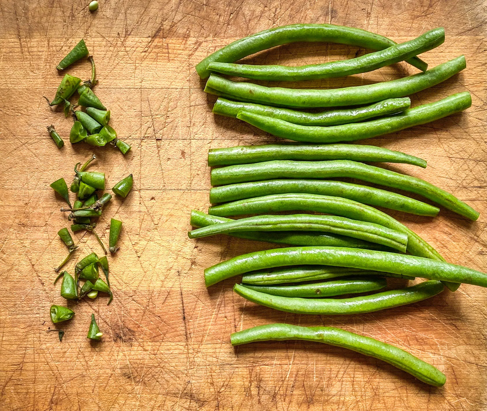 trimmed green beans on a cutting board